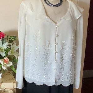 Cream colored long sleeve beaded top